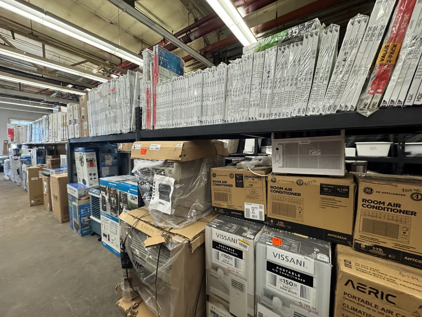 Shelves of discounted air conditioners and appliances at Saving Bodega