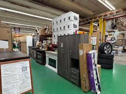Showroom floor at Saving Bodega featuring furniture, tires, and home goods